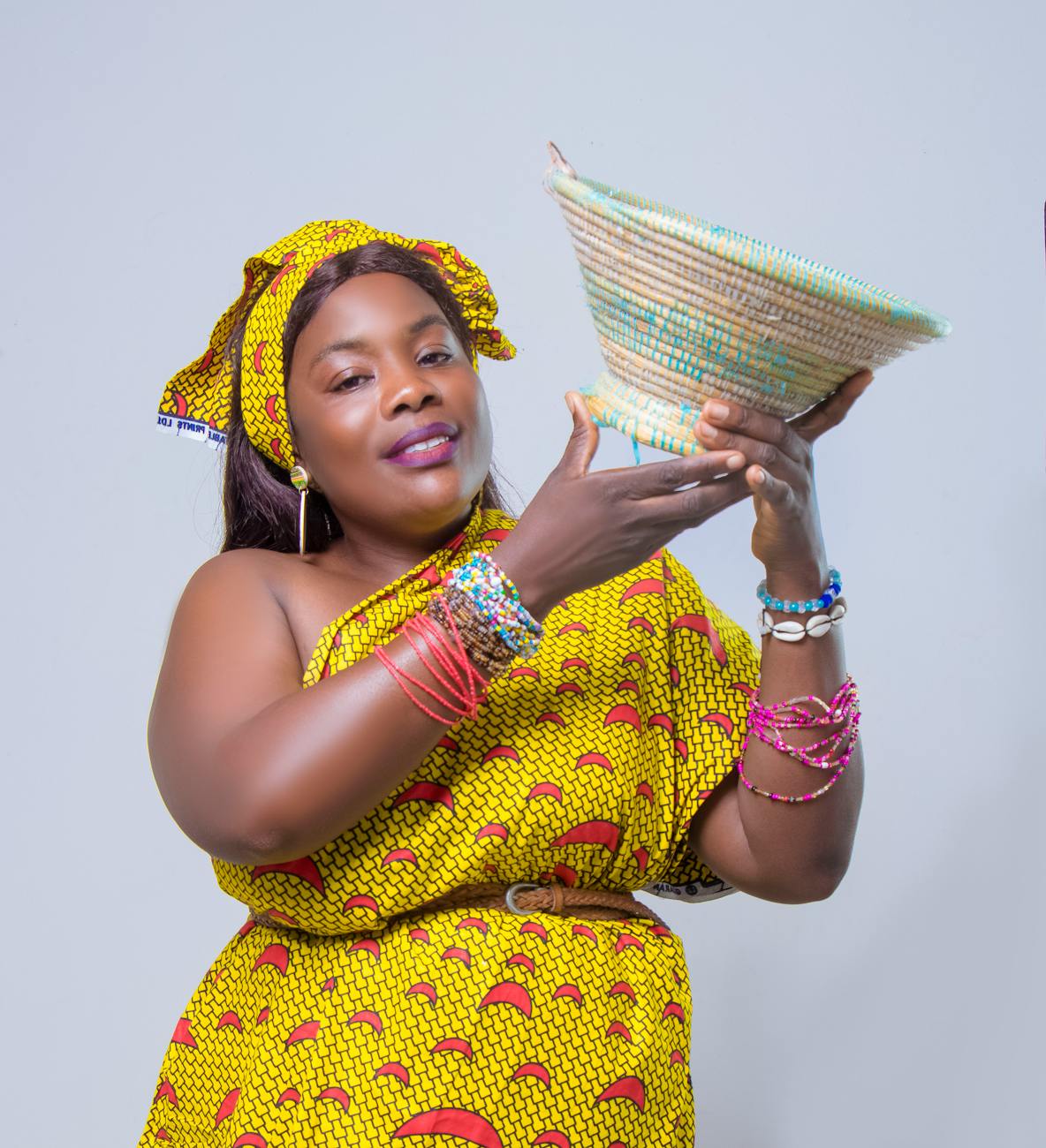 traditional african woman holding woven basket